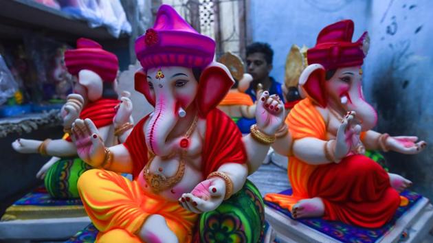 A painter surrounded by idols of Ganesha lends finishing touches to pieces before they head to their destinations. During Ganesh Chaturthi devotees will bring the elephant headed god home with festivities culminating with the immersion of idols, signifying his return to Mount Kailash and the artisans at Pen are optimistic they will do justice to their part in his journey. (Satish Bate / HT Photo) A painter surrounded by idols of Ganesha lends finishing touches to pieces before they head to their destinations. During Ganesh Chaturthi devotees will bring the elephant headed god home with festivities culminating with the immersion of idols, signifying his return to Mount Kailash and the artisans at Pen are optimistic they will do justice to their part in his journey. (Satish Bate / HT Photo)