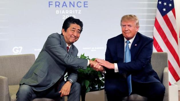 US President Donald Trump and Japan's Prime Minister Shinzo Abe shake hands as they attend a bilateral meeting during the G7 summit in Biarritz, France.(Reuters photo)