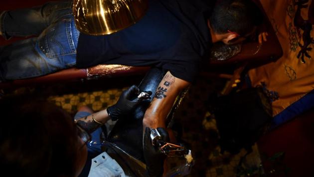 They include a so-called ambigram that from one angle reads “Hong Kong” and from another “add oil” -- a Cantonese expression of encouragement which has become one of the catchphrases of the unrest. (Lillian Suwanrumpha / AFP) They include a so-called ambigram that from one angle reads “Hong Kong” and from another “add oil” -- a Cantonese expression of encouragement which has become one of the catchphrases of the unrest. (Lillian Suwanrumpha / AFP)