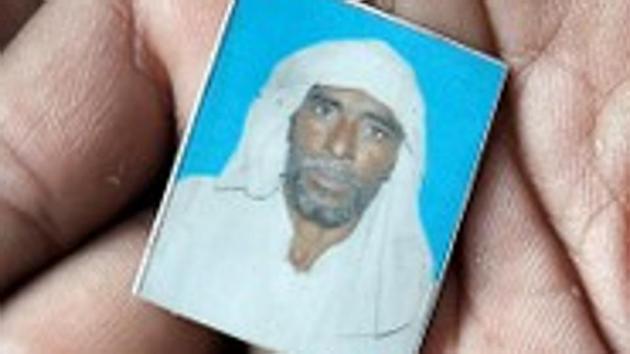 Irshad Khan holds a picture of his late father Pehlu, in Jaisinghpur.(Reuters File)