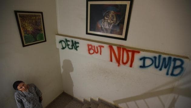 A slogan, ‘Deaf but not dumb’, on a wall at the Noida Deaf Society. Om Negi, 16, from Ghaziabad, and Uttam Tiwari, 17, from Patna had both attended schools for the hearing impaired, but were disappointed with the lack of infrastructure to accommodate their learning. They are now among 50 others attending remedial classes in Maths and English at the Noida Deaf Society, an NGO, which works for the education of deaf children. (Virendra Singh Gosain / HT Photo)