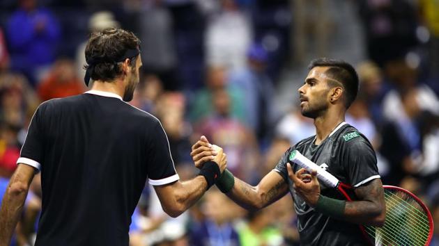 Roger Federer of Switzerland shakes hands with Sumit Nagal of India after their Men's Singles first round match on day one of the 2019 US Open.(AFP)