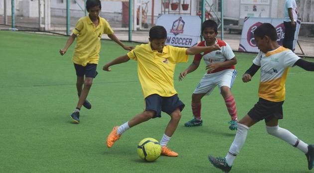 Matoshri English school (yellow) vs Ideal English school (white and yellow) in action at the Srujan Super Cup 2019 six-a-side slum football at the Tiger Play Turf in Shastrinagar on Sunday. (HT PHOTO) Matoshri English school (yellow) vs Ideal English school (white and yellow) in action at the Srujan Super Cup 2019 six-a-side slum football at the Tiger Play Turf in Shastrinagar on Sunday. (HT PHOTO)