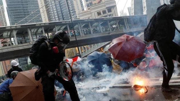 Demonstrators protect themselves from tear gas canisters during a protest in Tsuen Wan, Hong Kong .(Reuters Photo)