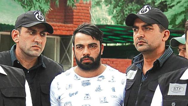 The Special Task Force (STF) Haryana police with gangster Kaushal who was arrested from Indira Gandhi International Airport early morning, at Police Commissioner Office, in Faridabad, Haryana, on Monday, August 26, 2019. (Photo by Yogendra Kumar / Hindustan Times) The Special Task Force (STF) Haryana police with gangster Kaushal who was arrested from Indira Gandhi International Airport early morning, at Police Commissioner Office, in Faridabad, Haryana, on Monday, August 26, 2019. (Photo by Yogendra Kumar / Hindustan Times)