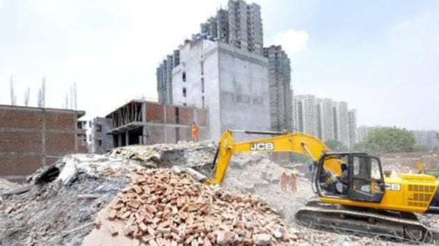 Greater Noida, India - July 19, 2018: National Disaster Response Force (NDRF) team continue their rescue operation as they search the debris on the third day of building collapse at Shahberi village, in Greater Noida, India, on Thursday, July 19, 2018. (Sunil Ghosh / Hindustan Times) Greater Noida, India - July 19, 2018: National Disaster Response Force (NDRF) team continue their rescue operation as they search the debris on the third day of building collapse at Shahberi village, in Greater Noida, India, on Thursday, July 19, 2018. (Sunil Ghosh / Hindustan Times)