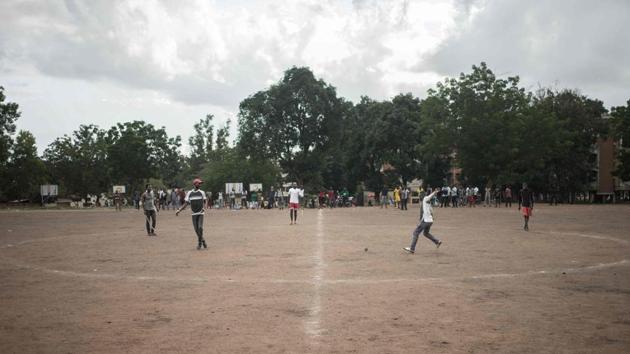 Ngbaba players compete for the puck on the field during a game. The aim is to avoid the puck stopping face down in your half of the pitch. At this match, played on a sports field at the University of Bangui, the challenges and skills of ngbaba were on clear display. Reaching the puck in time requires sharp reflexes, and it takes quick thinking and coordination to mount a counter-attack. (Florent Vergnes / AFP) Ngbaba players compete for the puck on the field during a game. The aim is to avoid the puck stopping face down in your half of the pitch. At this match, played on a sports field at the University of Bangui, the challenges and skills of ngbaba were on clear display. Reaching the puck in time requires sharp reflexes, and it takes quick thinking and coordination to mount a counter-attack. (Florent Vergnes / AFP)