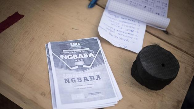 A puck and flyers for a Ngbaba game on the table of the Ngbaba arbitrator in Bangui. At the start of the century, ngbaba’s fortunes began a downward spiral and people became afraid of going into other neighbourhoods. “These days, young people prefer to play football or basketball, because they have a better chance of making a living from those sports,” said Jean, a student. “What we need is a professional federation.” (Florent Vergnes / AFP) A puck and flyers for a Ngbaba game on the table of the Ngbaba arbitrator in Bangui. At the start of the century, ngbaba’s fortunes began a downward spiral and people became afraid of going into other neighbourhoods. “These days, young people prefer to play football or basketball, because they have a better chance of making a living from those sports,” said Jean, a student. “What we need is a professional federation.” (Florent Vergnes / AFP)