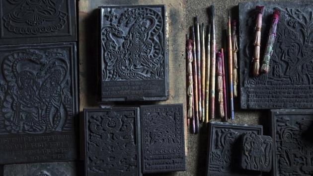 Wooden stamps used to make traditional paintings, displayed at the residence of Tej Kumari and Purna. Both learned to paint in the Chitrakar style from their fathers and grandfathers, knowledge passed down over generations. However, they are not sure if the next generation will continue the tradition. Their two sons work in businesses but their third son is showing some interest in the trade. (Niranjan Shrestha / AP) Wooden stamps used to make traditional paintings, displayed at the residence of Tej Kumari and Purna. Both learned to paint in the Chitrakar style from their fathers and grandfathers, knowledge passed down over generations. However, they are not sure if the next generation will continue the tradition. Their two sons work in businesses but their third son is showing some interest in the trade. (Niranjan Shrestha / AP)