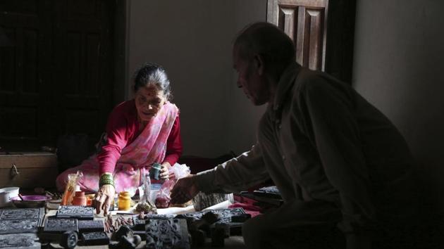 Tej Kumari and Purna (R) prepare to make paintings at their residence. The Chitrakars were given their title, now their family name, by 14th century King Jayasthiti Malla. Malla classified the Newar ethnic group of Kathmandu under a caste system according to occupations passed down generations, with different families taking on roles as priests, artisans, fishermen, cleaners, etc. With this, higher and lower castes also emerged. (Niranjan Shrestha / AP) Tej Kumari and Purna (R) prepare to make paintings at their residence. The Chitrakars were given their title, now their family name, by 14th century King Jayasthiti Malla. Malla classified the Newar ethnic group of Kathmandu under a caste system according to occupations passed down generations, with different families taking on roles as priests, artisans, fishermen, cleaners, etc. With this, higher and lower castes also emerged. (Niranjan Shrestha / AP)