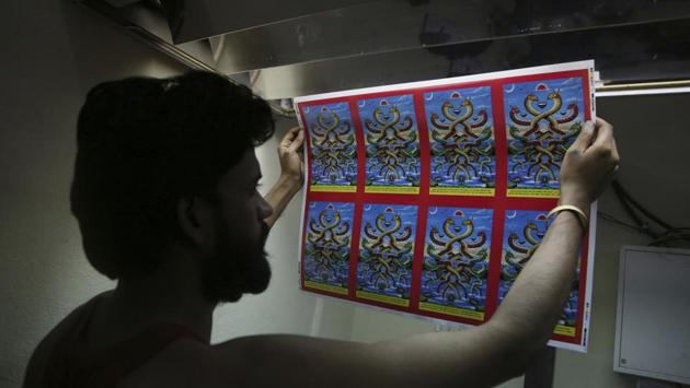A Nepalese man checks newly printed posters at a printing press in Kathmandu. There are just 10 or fewer families now painting in the traditional style, which is denoted by its vivid palette of plant-based paints. (Niranjan Shrestha / AP) A Nepalese man checks newly printed posters at a printing press in Kathmandu. There are just 10 or fewer families now painting in the traditional style, which is denoted by its vivid palette of plant-based paints. (Niranjan Shrestha / AP)