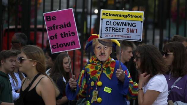 A man dressed as a clown and wearing a Boris Johnson mask protests in front of the Downing Street gate in London, Thursday, Aug. 29, 2019. (AP Photo) A man dressed as a clown and wearing a Boris Johnson mask protests in front of the Downing Street gate in London, Thursday, Aug. 29, 2019. (AP Photo)