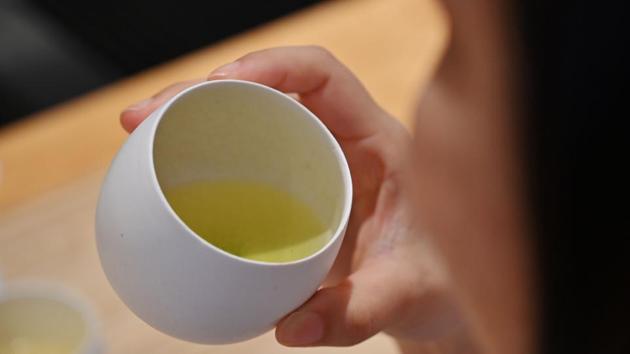 A woman drinking Japanese tea at a tea salon in Tokyo. Traditional Japanese tea also suffers from something of an image problem, argues Suzuki, as it is considered the preserve of older generations. “It is mainly the over-60s who drink tea. The younger people are, the more they drink coffee... Tea is no longer attractive to customers. Our priority is to boost its appeal,” he said. (Charly Triballeau / AFP) 