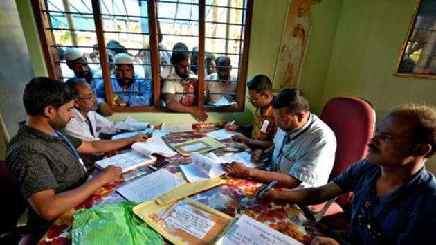 People wait to check their names on the draft list at the National Register of Citizens (NRC) centre at a village in Nagaon district, Assam.(Reuters Photo)