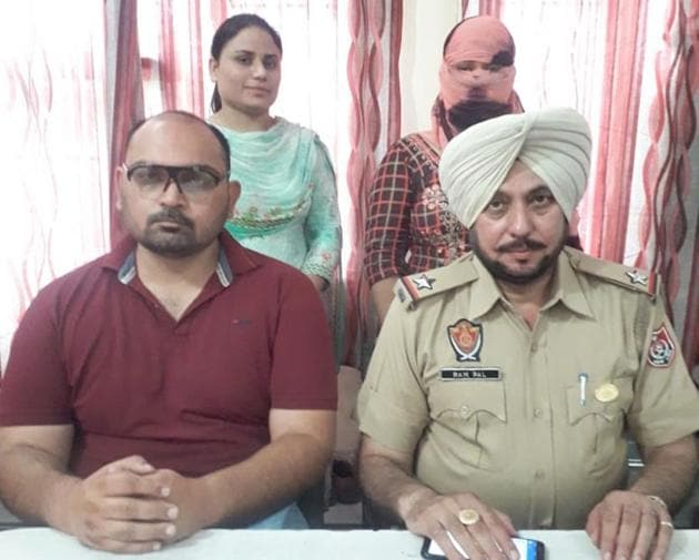 The accused (face covered) in police custody on Thursday. (HT Photo) The accused (face covered) in police custody on Thursday. (HT Photo)