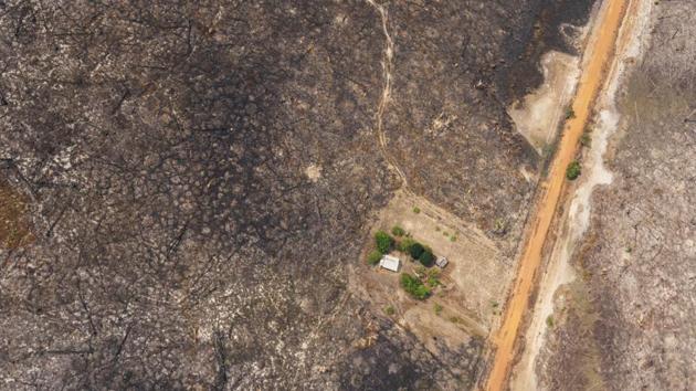 A house is seen surrounded by land scorched by wildfires near Vila Nova Samuel, Brazil. Lingering smoke in the Amazon has caused concern among Brazilians who say that respiratory problems, particularly among children and the elderly, have increased as fires in the region rage. (Victor R. Caivano / AP) A house is seen surrounded by land scorched by wildfires near Vila Nova Samuel, Brazil. Lingering smoke in the Amazon has caused concern among Brazilians who say that respiratory problems, particularly among children and the elderly, have increased as fires in the region rage. (Victor R. Caivano / AP)