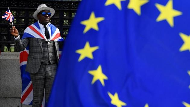 A pro-Brexit protester stands behind an EU flag. (Reuters Photo) A pro-Brexit protester stands behind an EU flag. (Reuters Photo)