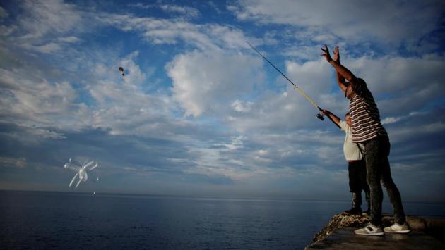 Fishermen throw inflated condoms carrying baited hooks for fishing at the seafront Malecon in Havana, Cuba. (Alexandre Meneghini / REUTERS) Fishermen throw inflated condoms carrying baited hooks for fishing at the seafront Malecon in Havana, Cuba. (Alexandre Meneghini / REUTERS)
