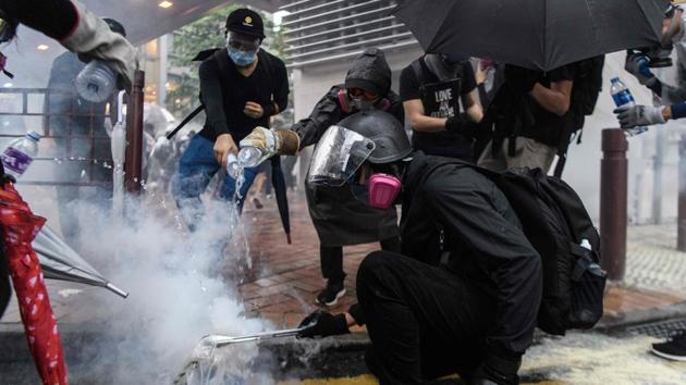 “We’ve been to a lot of protests since June, nearly every weekend,” Abby said. “It’s not about having fun. But it is very good to share the experience with someone... it’s unique.” The couple travel to protests together, transforming from inconspicuous students into black-clad rebels in shopping mall toilets, faces covered by gas masks and goggles, taking positions a few rows back from the hardcore demonstrators who throw bricks at the police. (Anthony Wallace / AFP) “We’ve been to a lot of protests since June, nearly every weekend,” Abby said. “It’s not about having fun. But it is very good to share the experience with someone... it’s unique.” The couple travel to protests together, transforming from inconspicuous students into black-clad rebels in shopping mall toilets, faces covered by gas masks and goggles, taking positions a few rows back from the hardcore demonstrators who throw bricks at the police. (Anthony Wallace / AFP)