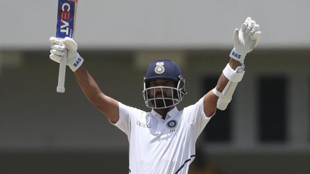 Ajinkya Rahane celebrates after he scores a century against West Indies during the first Test.(AP)