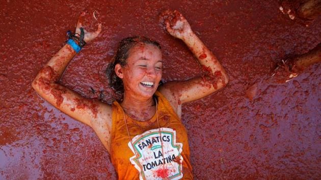 A reveller lies in tomato pulp during the annual “La Tomatina” tomato food fight festival in Bunol, near Valencia, Spain. (Heino Kalis / REUTERS) A reveller lies in tomato pulp during the annual “La Tomatina” tomato food fight festival in Bunol, near Valencia, Spain. (Heino Kalis / REUTERS)