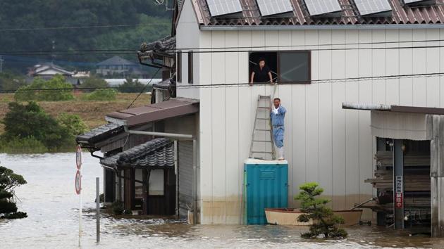 A flood-affected resident receives help following heavy rains in Omachi, Saga prefecture, Japan. At least two people were confirmed dead this week as heavy rains pounded southwest Japan, prompting flood and landslide warnings and orders for 870,000 people to seek safety. (Jiji Press / AFP) A flood-affected resident receives help following heavy rains in Omachi, Saga prefecture, Japan. At least two people were confirmed dead this week as heavy rains pounded southwest Japan, prompting flood and landslide warnings and orders for 870,000 people to seek safety. (Jiji Press / AFP)