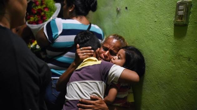America del Carmen Gomez cries at the wake of her daughter Xochitl Nayeli Irineo Gomez, 24, one of the victims of the attack at the Caballo Blanco bar, in Coatzacoalcos, Veracruz, Mexico. At least 26 people were killed and 11 badly wounded after gunmen trapped revellers inside the Caballo Blanco bar (White Horse bar) and started a raging fire on August 27. (Victoria Razo / AFP) America del Carmen Gomez cries at the wake of her daughter Xochitl Nayeli Irineo Gomez, 24, one of the victims of the attack at the Caballo Blanco bar, in Coatzacoalcos, Veracruz, Mexico. At least 26 people were killed and 11 badly wounded after gunmen trapped revellers inside the Caballo Blanco bar (White Horse bar) and started a raging fire on August 27. (Victoria Razo / AFP)
