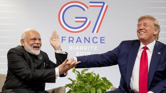 Prime Minister Narendra Modi slaps the hand of President Donald Trump as they share a laugh during a bilateral meeting at the G-7 summit in Biarritz, France. (Andrew Harnik / AP) 