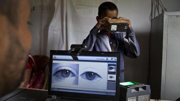 A National Register of Citizens (NRC) officer takes a photograph of the eyes of a boy at an NRC centre on the eve of the release of the final NRC draft in Guwahati, Assam. (Anupam Nath / AP) 