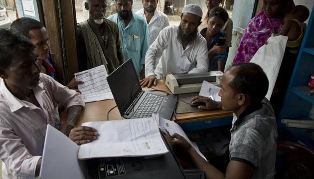People check their names in the final list of the National Register of Citizens (NRC) and take out prints at an internet shop in Pabhokati village in Morigaon district of Assam, Saturday, Aug. 31, 2019.(AP photo) People check their names in the final list of the National Register of Citizens (NRC) and take out prints at an internet shop in Pabhokati village in Morigaon district of Assam, Saturday, Aug. 31, 2019.(AP photo)