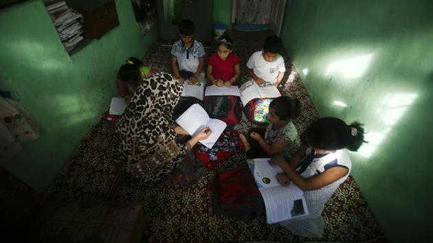 Kashmiri children attend private classes at a teacher's residence in Srinagar, Jammu and Kashmir. The government imposed a security lockdown and communications blackout in Muslim-majority Kashmir to avoid a violent reaction to the August 05 decision to downgrade the region's autonomy. (Mukhtar Khan / AP) 