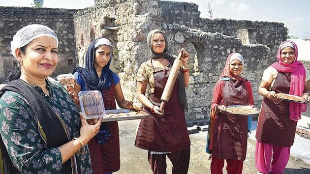 Pooja Sharma (extreme left) said she is the first woman in Chandu village to step out of her house to work. With the help of an NGO in 2017, Sharma helped set up a bakery that aimed to empower women in the villages, by giving them stable employment. The bakery is run out of a 250-year-old haveli that belongs to Sharma’s family. (Yogendra Kumar/HT PHOTO) Pooja Sharma (extreme left) said she is the first woman in Chandu village to step out of her house to work. With the help of an NGO in 2017, Sharma helped set up a bakery that aimed to empower women in the villages, by giving them stable employment. The bakery is run out of a 250-year-old haveli that belongs to Sharma’s family. (Yogendra Kumar/HT PHOTO)