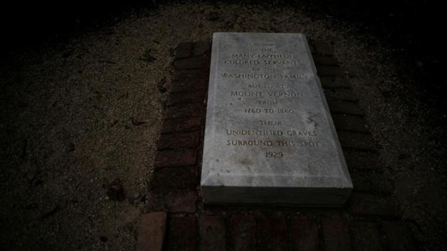 A plaque reads, “In memory of the many faithful coloured servants of the Washington Family buried at Mount Vernon from 1760 to 1860. Their unidentified graves surround this spot, 1929.” is seen at Mount Vernon estate, home of George Washington, the first President of the United States.  (Carlos Barria / REUTERS) 