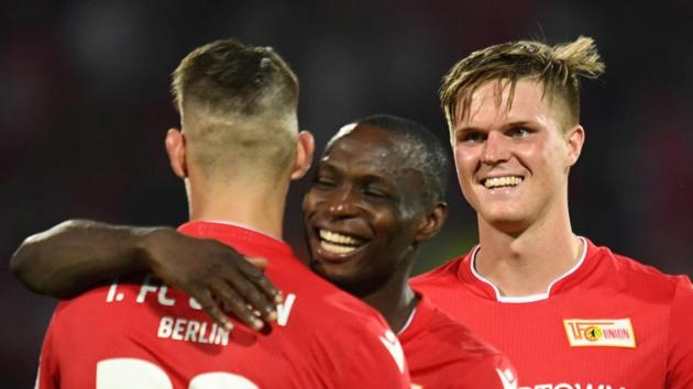 FC Union Berlin's Anthony Ujah, Robert Andrich and Marius Bulter celebrate after the match.(REUTERS) FC Union Berlin's Anthony Ujah, Robert Andrich and Marius Bulter celebrate after the match.(REUTERS)