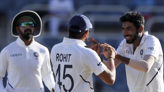 India's Jasprit Bumrah, right, celebrates with Rohit Sharma taking the wicket of West Indies' captain Jason Holder. (AP)