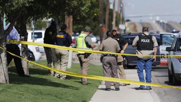 Authorities cordon off a part of the sidewalk in the 5100 block of E. 42nd Street in Odessa, Texas, Saturday, Aug. 31, 2019. Several people were dead after a gunman who hijacked a postal service vehicle in West Texas shot more than 20 people, authorities said Saturday. The gunman was killed and a few law enforcement officers were among the injured. (Mark Rogers/Odessa American via AP) (AP) Authorities cordon off a part of the sidewalk in the 5100 block of E. 42nd Street in Odessa, Texas, Saturday, Aug. 31, 2019. Several people were dead after a gunman who hijacked a postal service vehicle in West Texas shot more than 20 people, authorities said Saturday. The gunman was killed and a few law enforcement officers were among the injured. (Mark Rogers/Odessa American via AP) (AP)