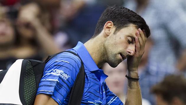 Novak Djokovic walks off the court as he retires during his match against Stan Wawrinka.(AP)