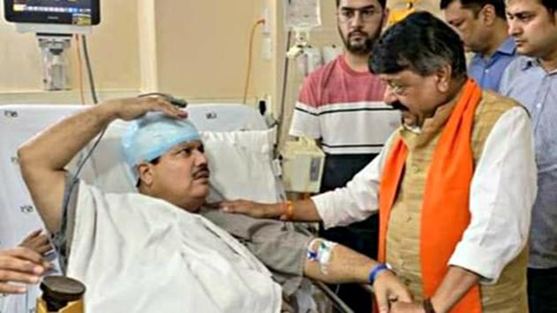 BJP National general secretary Kailash Vijayvargiya meets BJP Lok Sabha lawmaker from West Bengal’s Barrackpore Arjun Singh who was injured during a protest against the Trinamool Congress in North 24 Parganas on Sunday.(ANI photo)