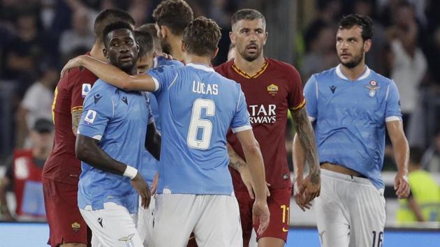 Roma and Lazio players hug at the end of a Serie A match.(AP)