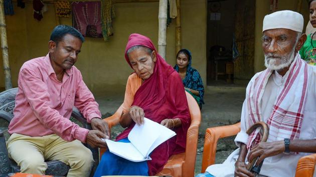 Khaibar Ali (43) along with his father Jahur Ali (73) and mother Sarifa Bebi (54) check the names in the recently published final list of the National Register of Citizens, Baska district, Assam, September 1, 2019(PTI)
