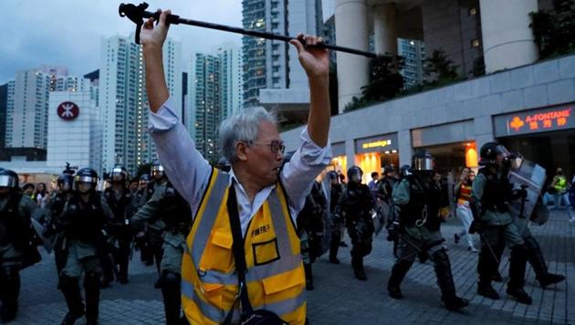 A man tries to block the riot police outside a metro station, in Hong Kong, China(REUTERS)