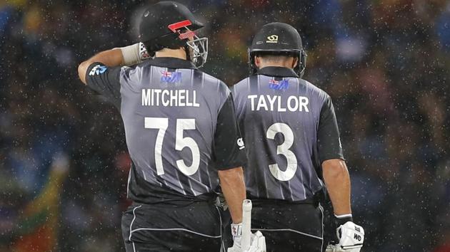 New Zealand's Ross Taylor, right, leaves the pitch after being dismissed as Mitchell Santner walks along.(AP)