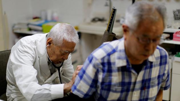 Nagayama examines a patient at his hospital in Tokyo. "Since I joined Fuwaku Club, I have broken ribs many times and broke my collarbone too," he said. "I can't stand not playing. (Kim Kyung-Hoon / REUTERS) Nagayama examines a patient at his hospital in Tokyo. "Since I joined Fuwaku Club, I have broken ribs many times and broke my collarbone too," he said. "I can't stand not playing. (Kim Kyung-Hoon / REUTERS)
