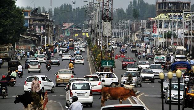 Vehicles ply after restrictions were eased in Srinagar on Saturday.(ANI photo)