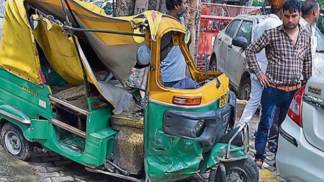 Passerby look at the mangled remains of an auto and a motorbike, which met with an accident after the driver of a dumper truck lost control and ran over autos and pedestrians near India Gate on Man Singh Road last night, is seen at Police Station Tilak Marg, in New Delhi. (Photo: PTI) Passerby look at the mangled remains of an auto and a motorbike, which met with an accident after the driver of a dumper truck lost control and ran over autos and pedestrians near India Gate on Man Singh Road last night, is seen at Police Station Tilak Marg, in New Delhi. (Photo: PTI)
