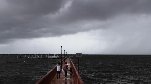 People walk along the Boardwalk Run as Hurricane Dorian continues to make its way toward the Florida coast in Stuart, Florida. Hundreds of thousands of people in Florida, Georgia and South Carolina were ordered to evacuate before the storm rolls up the Eastern Seaboard, bringing the possibility of life-threatening storm-surge flooding even if the storm’s heart stays offshore, as forecast. Several large airports announced closures and many flights were cancelled for Monday and Tuesday. (Joe Raedle/Getty Images/AFP) People walk along the Boardwalk Run as Hurricane Dorian continues to make its way toward the Florida coast in Stuart, Florida. Hundreds of thousands of people in Florida, Georgia and South Carolina were ordered to evacuate before the storm rolls up the Eastern Seaboard, bringing the possibility of life-threatening storm-surge flooding even if the storm’s heart stays offshore, as forecast. Several large airports announced closures and many flights were cancelled for Monday and Tuesday. (Joe Raedle/Getty Images/AFP)