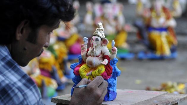 An artist gives final touches on a Ganesha idol ahead of sale on the eve of the Ganesh Chaturthi festival, at a roadside market in Noida. This year, the festival is being held from September 02 to September 12. (Sunil Ghosh / HT Photo) An artist gives final touches on a Ganesha idol ahead of sale on the eve of the Ganesh Chaturthi festival, at a roadside market in Noida. This year, the festival is being held from September 02 to September 12. (Sunil Ghosh / HT Photo)