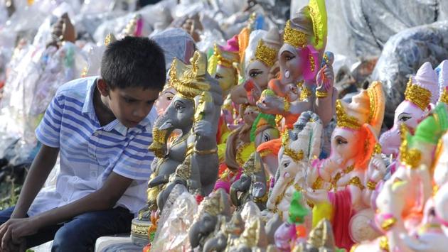 A child is seen with various Ganesha idols for sale on the eve of the Ganesh Chaturthi, in Noida. The festival is most commonly associated with the state of Maharashtra, while celebrations also occur in Tamil Nadu, Goa and Kerala. The ten day festival is also celebrated in Delhi with the presence of at least two dozen Ganesh Mandals. (Sunil Ghosh / HT Photo) A child is seen with various Ganesha idols for sale on the eve of the Ganesh Chaturthi, in Noida. The festival is most commonly associated with the state of Maharashtra, while celebrations also occur in Tamil Nadu, Goa and Kerala. The ten day festival is also celebrated in Delhi with the presence of at least two dozen Ganesh Mandals. (Sunil Ghosh / HT Photo)