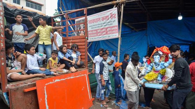 Devotees carry an idol of Ganesha at Versova, in Mumbai. Despite hurdles, Maharashtra welcomed Ganesha, also known as ‘Vighnaharta’ (remover of obstacles), for the state’s biggest public festival. More than a million big, medium and small idols of Lord Ganesha adorn homes of commoners to celebrities, industrialists, politicians, housing complexes, private and public companies across the state. (Ragul Krishnan / HT Photo) Devotees carry an idol of Ganesha at Versova, in Mumbai. Despite hurdles, Maharashtra welcomed Ganesha, also known as ‘Vighnaharta’ (remover of obstacles), for the state’s biggest public festival. More than a million big, medium and small idols of Lord Ganesha adorn homes of commoners to celebrities, industrialists, politicians, housing complexes, private and public companies across the state. (Ragul Krishnan / HT Photo)