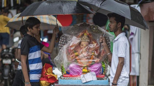 Devotees carry an idol of the Hindu god Ganesha from a workshop to a place of worship at Chinchpokli in Mumbai. Devotees of Ganesha look forward all year to Ganesh Chaturthi or Ganeshotsav, a 10-day festival during which Ganesha idols are brought home or to public pandals and followed by days of boisterous festivities. (Pratik Chorge / HT Photo) Devotees carry an idol of the Hindu god Ganesha from a workshop to a place of worship at Chinchpokli in Mumbai. Devotees of Ganesha look forward all year to Ganesh Chaturthi or Ganeshotsav, a 10-day festival during which Ganesha idols are brought home or to public pandals and followed by days of boisterous festivities. (Pratik Chorge / HT Photo)